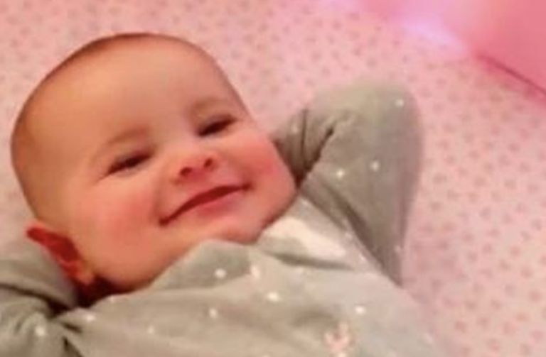 Dad Sees Happy Baby Stretched Out And Grinning In Crib In The Morning And Records Her