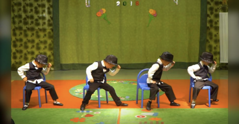 Four preschoolers take stage in suits to impress crowd with their slick moves