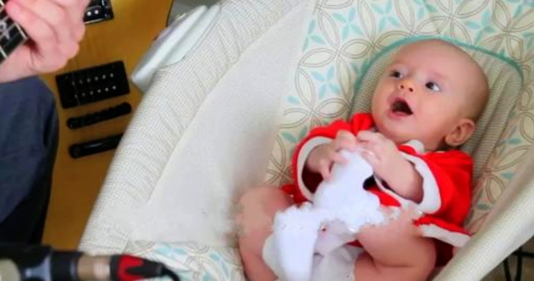 4 month old daughter steals the spotlight from daddy during his Christmas song performance