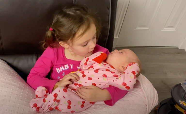 Big Sister Puts Little Sister to Sleep. So cute