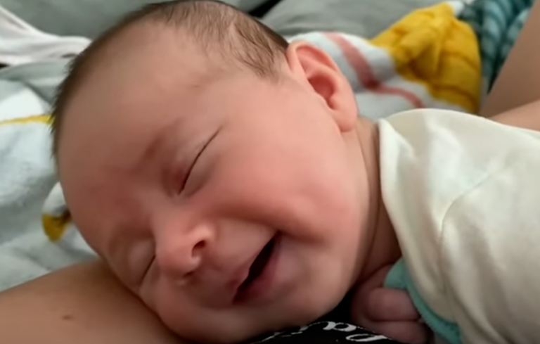 Heartwarming Sight: Newborn Baby Smiling in Dream, Perhaps Dreaming About Milk!