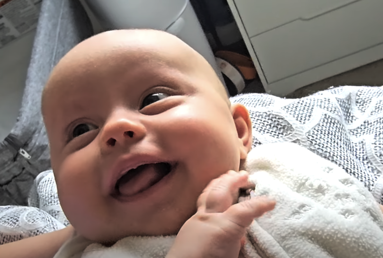 A Newborn’s Adorable Smiles Capture Hearts