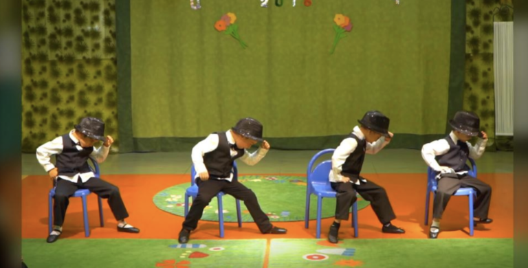 Four preschoolers take stage in suits to impress crowd with their slick moves