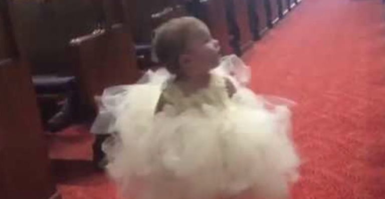 Baby flower girl is walking down the aisle and makes every wedding guest laugh when she sees her dad