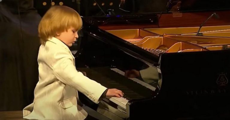 Teeny boy sits at piano stealing the show with his masterful performance