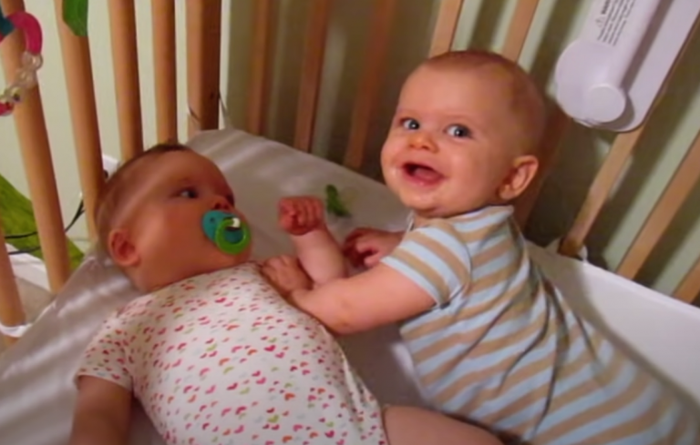 Playful Pandemonium: Cute Twins Engage in Adorable Crib Fight!