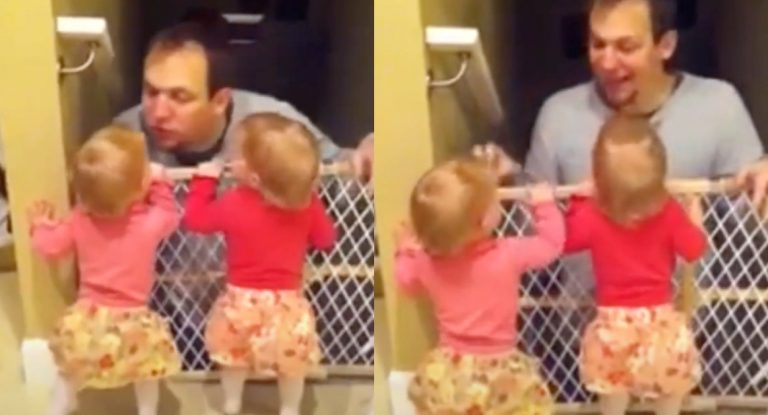 Identical twins Ella and Halle wait for their dad to come in from the garage.