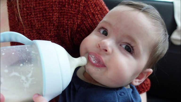 A hungry baby drinking milk in such a cute way.