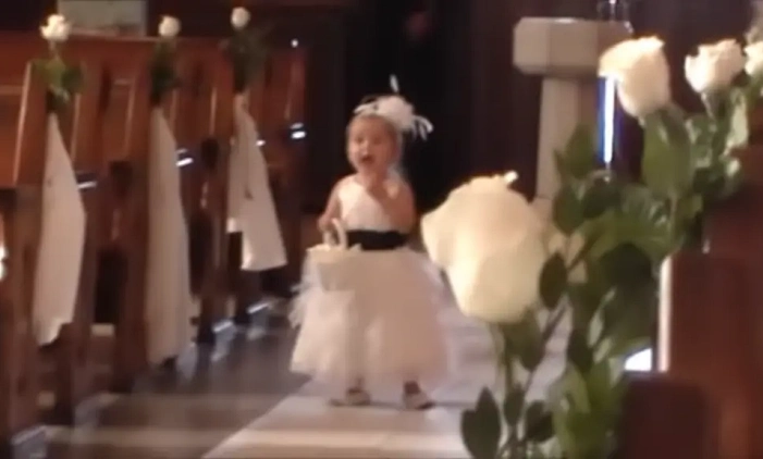 Crowd Cracks Up as Flower Girl Walks Down the Aisle Yelling for the Groom