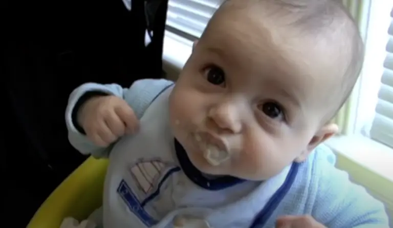 Brighton eating first banana rice cereal meal.